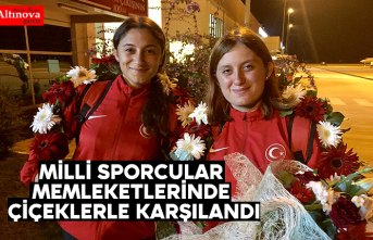 Milli sporcular memleketlerinde çiçeklerle karşılandı