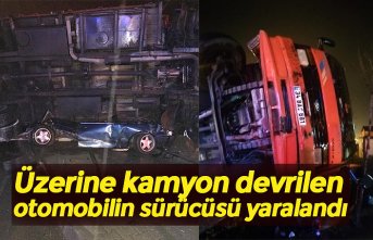 Üzerine kamyon devrilen otomobilin sürücüsü yaralandı