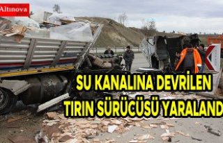 Su kanalına devrilen tırın sürücüsü yaralandı